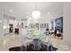 Open-concept living and dining area with modern lighting and access to kitchen at 8813 Covey Rise Ct, Charlotte, NC 28226