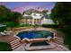 Inviting backyard oasis with a large swimming pool, hot tub, and lush landscaping perfect for relaxation and entertaining at 8813 Covey Rise Ct, Charlotte, NC 28226