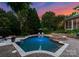 Stunning backyard pool with spa, lush landscaping, and surrounding greenery, perfect for outdoor relaxation at 8813 Covey Rise Ct, Charlotte, NC 28226