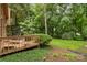 Inviting back deck overlooking a serene wooded yard with a patio set and lush greenery at 8968 St Croix Ln, Charlotte, NC 28277
