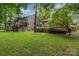 Expansive backyard featuring mature trees and a multi-tiered deck perfect for outdoor entertaining at 8968 St Croix Ln, Charlotte, NC 28277
