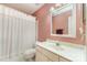 This bathroom includes a toilet, shower with a white curtain, and a vanity with mirror and lighting at 8968 St Croix Ln, Charlotte, NC 28277
