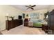 Comfortable bedroom with carpeted floors, a ceiling fan, and natural light at 8968 St Croix Ln, Charlotte, NC 28277