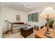 This cozy bedroom includes a comfortable sofa, a wooden chest, and a window for natural light at 8968 St Croix Ln, Charlotte, NC 28277