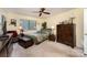 This comfortable bedroom has a ceiling fan, and a well-lit window allowing lots of natural light at 8968 St Croix Ln, Charlotte, NC 28277
