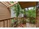 Charming deck with wood railing, potted plants, and a view of the surrounding greenery at 8968 St Croix Ln, Charlotte, NC 28277