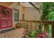 Inviting entrance with a red door, lush plants, and wooden accents for a warm welcome at 8968 St Croix Ln, Charlotte, NC 28277
