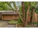 Inviting brown home featuring an attached two-car garage and a classic brick chimney at 8968 St Croix Ln, Charlotte, NC 28277