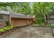 Exterior shot featuring the home's attached two-car garage, driveway, and well-maintained landscaping at 8968 St Croix Ln, Charlotte, NC 28277