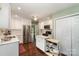 Modern kitchen with white cabinets, stainless steel appliances, and hardwood floors at 8968 St Croix Ln, Charlotte, NC 28277