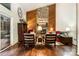 Inviting living room featuring a striking stone fireplace, wood paneling, and abundant natural light at 8968 St Croix Ln, Charlotte, NC 28277