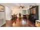 Inviting living room featuring hardwood floors, a ceiling fan, and ample natural light from the windows at 8968 St Croix Ln, Charlotte, NC 28277