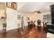 Bright living room featuring hardwood floors, and stairs leading to a cozy second floor with railing detail at 8968 St Croix Ln, Charlotte, NC 28277