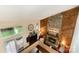 A living room featuring stone fireplace, wood paneling, and natural light at 8968 St Croix Ln, Charlotte, NC 28277