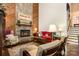 Charming living room featuring a stone fireplace and hardwood floors at 8968 St Croix Ln, Charlotte, NC 28277