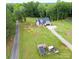 Charming home on a large lot with a chicken coop, surrounded by lush greenery, and a long driveway at 943 Shinnville Rd, Mooresville, NC 28115