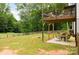 Multi-level backyard with a patio underneath a wooden deck overlooking the yard at 943 Shinnville Rd, Mooresville, NC 28115