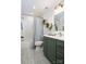 Bathroom with modern green vanity and tiled shower at 943 Shinnville Rd, Mooresville, NC 28115