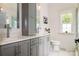 Bathroom featuring double vanity with gray cabinets and white marble countertop at 943 Shinnville Rd, Mooresville, NC 28115