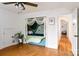 Charming bedroom featuring a cozy reading nook, wood floors, and access to an adjacent area, creating an inviting retreat at 943 Shinnville Rd, Mooresville, NC 28115