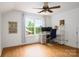 Versatile bedroom featuring a ceiling fan, desk area, and hardwood floors, creating a comfortable and functional space at 943 Shinnville Rd, Mooresville, NC 28115