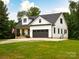 Beautiful modern farmhouse with a covered front porch and a two-car garage at 943 Shinnville Rd, Mooresville, NC 28115
