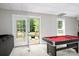 Entertaining game room with a pool table and access to an outdoor patio, perfect for gatherings and relaxation at 943 Shinnville Rd, Mooresville, NC 28115