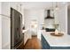 Kitchen featuring a blue island with white countertops and stainless steel appliances at 943 Shinnville Rd, Mooresville, NC 28115