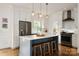 Modern kitchen featuring white cabinets, a center island, and stainless steel appliances at 943 Shinnville Rd, Mooresville, NC 28115