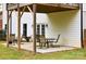 Covered backyard patio with an outdoor dining set and white exterior house siding at 943 Shinnville Rd, Mooresville, NC 28115