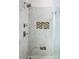 Luxurious walk-in shower featuring marble tile and recessed shelving at 943 Shinnville Rd, Mooresville, NC 28115