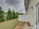 Side yard showcases a vinyl fence, lush evergreens, and a small patio at 954 Taybyn Rd, Fort Mill, SC 29715
