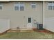 Backyard with small patio area, white vinyl fence, and tidy landscaping at 954 Taybyn Rd, Fort Mill, SC 29715