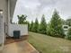 Serene backyard with lush lawn, privacy fence, and tall evergreens at 954 Taybyn Rd, Fort Mill, SC 29715