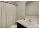 Clean bathroom with a modern vanity, ample lighting, and a shower with patterned curtain at 954 Taybyn Rd, Fort Mill, SC 29715