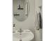 Clean bathroom featuring a round mirror, patterned wallpaper, and chrome fixtures at 954 Taybyn Rd, Fort Mill, SC 29715