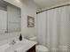 Well-lit bathroom featuring a shower with a striped curtain, a modern mirror, and vanity at 954 Taybyn Rd, Fort Mill, SC 29715