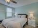 Cozy bedroom featuring a queen bed, ceiling fan, and a nightstand with a lamp at 954 Taybyn Rd, Fort Mill, SC 29715