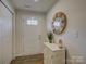 Bright foyer with a white cabinet, decorative mirror, and wood-look flooring at 954 Taybyn Rd, Fort Mill, SC 29715