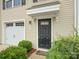 Close up of the front door and garage of the home, enhanced by green landscaping at 954 Taybyn Rd, Fort Mill, SC 29715