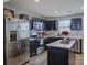 Well-equipped kitchen boasts stainless steel appliances and dark cabinetry with white countertops at 954 Taybyn Rd, Fort Mill, SC 29715
