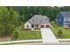 Aerial view of a brick home with a landscaped yard and two-car garage at 9833 Ardley Park Way, Mint Hill, NC 28227