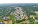 An aerial view shows the location of the home in a community with mature trees at 9833 Ardley Park Way, Mint Hill, NC 28227