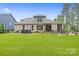 Lush backyard featuring a patio, hot tub, and well-manicured lawn at 9833 Ardley Park Way, Mint Hill, NC 28227