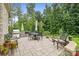 Backyard patio with outdoor kitchen, seating area, and stone pavers at 9833 Ardley Park Way, Mint Hill, NC 28227