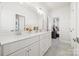 Bright bathroom with a double sink vanity, white cabinetry, and decorative jars at 9833 Ardley Park Way, Mint Hill, NC 28227