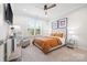 Cozy bedroom with neutral colors, a ceiling fan, and ample natural light creating a relaxing atmosphere at 9833 Ardley Park Way, Mint Hill, NC 28227