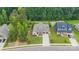 Beautiful home with a manicured lawn, mature trees, two-car garage, and a concrete driveway at 9833 Ardley Park Way, Mint Hill, NC 28227
