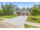 Beautiful home with a manicured lawn, mature trees, two-car garage, and a concrete driveway at 9833 Ardley Park Way, Mint Hill, NC 28227