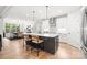 Bright kitchen features a large island, modern white cabinetry, and stainless steel appliances at 9833 Ardley Park Way, Mint Hill, NC 28227
